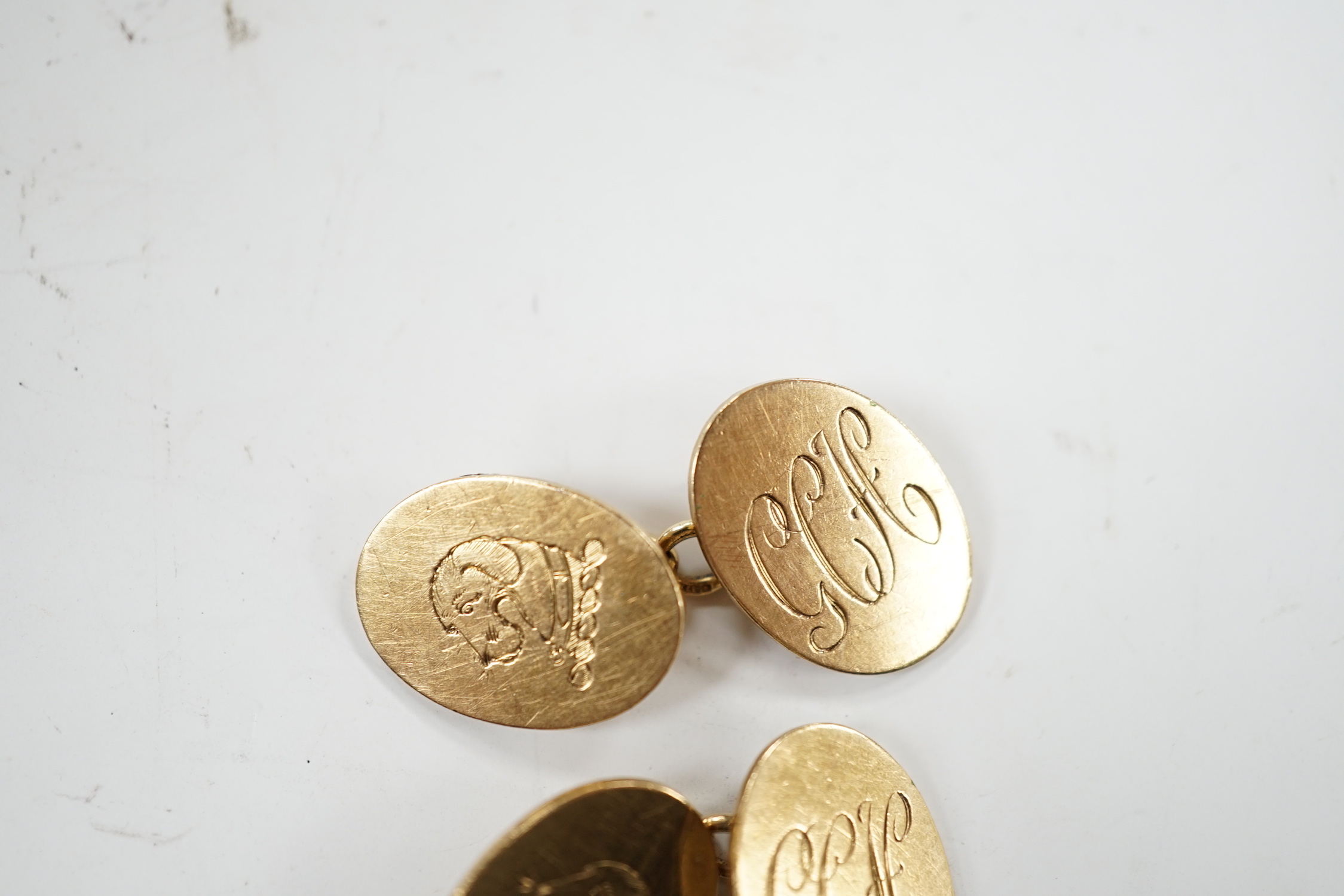 A pair of early 1960's 9ct gold oval cufflinks, with engraved crest and monogram, 10.3 grams.